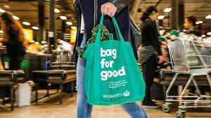 The animal lover from australia strategically cut holes in the green eco bag for the puppy's legs and head to stick through. Plastic Bag Ban Woolworths To Issue Free Reusable Bags After Backflip