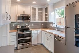 White Cabinets Butcher Block Counter Small Kitchen Stainless Steel Appliances Concrete Floor Michael Lindberg Kitchen Small Kitchen Butcher Block Counter