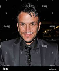 Peter Andre in a black suit, black shirt and black tie returning to his  hotel London, England