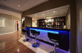 To modernize their basement bar, these homeowners opted for a shiny chrome subway tile backsplash instead of the classic white option. 21 Stunning Modern Basement Designs Modern Basement Modern Basement Bar Basement Bar Designs