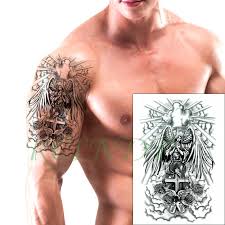 In a markedly religious piece, these angel wings hover behind a cross on the rib cage. Waterproof Temporary Tattoo Sticker Angel Wings Cross Bird Rose Flower Fake Tatto Flash Tatoo Large Size Tattoos For Women Men Nana S Corner Beauty Cosmetic