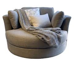 Settle into your favorite cozy reading chair on a rainy day at home. Our Furniture Warehouse Large Cozy Cuddle Chair With 360 Rotation In Sunlight Smoke
