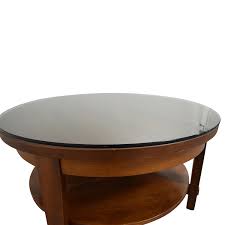 Mahogany coffee table centers the room with its warm coffee color and global, marketplace feel. Tech Buzz Socialist 32 Round Coffee Table Crate And Barrel