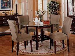 A sleek, round metal table topped with glass is so modern that it's practically futuristic. Glass Dining Table Round Glass Dining Tables On Round Glass Dining Room Table Round Dining Room Table Dining Room Design Round Table Round Dining Room