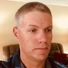 I see no need for the green arrow. Also, a <----> sign and a guardrail are  needed to prevent drivers from driving down the trail, especially at night.  FYI the road ahead