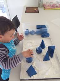 Geometrical Volumes And A Flour Tray Montessori Sensorial Geometry Montessori Geometrie