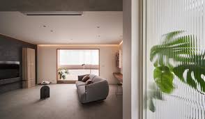 Green sofa with pillow near stay home lettering. This Home Looks Like A Fabulous Art Gallery