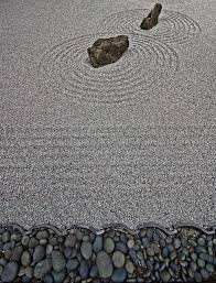 Boulders support a border that includes forest pansy redbud, japanese forest grass, and lady's mantle. Zen Garden Japanese Garden Zen Garden Zen Rock Garden