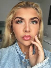 Green Eyes Long Eyelashes Glossy Lips Blonde Hair Jean Jacket Tan Skin And Hoop Earrings Glossy Lips Longer Eyelashes Tan Skin