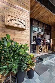 This Cafe Has A Simple Color Palette Of Wood White And Black With A Touch Of Green From The Plants Coffee Shop Design Small Coffee Shop Coffee Shop