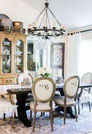 A vintage french provincial style dining set offers white paint decorated chairs having tall pressed caned backs with scroll crest flanked by turned finials surmounting padded seats. French Dining Room Update With Velvet Slipcovered Chairs Tidbits Twine