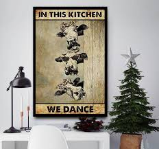 Highlight your décor arrangement when you showcase the inviting touch of text printed on this wall sign boasting an effortlessly appealing wooden backing. Cows In This Kitchen We Dance Canvas