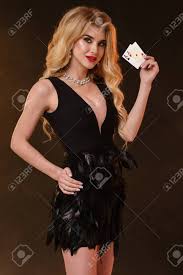 It was a 3 peice dress. Gorgeous Curly Blonde Female Bright Make Up In Black Dress With Feathers And Necklace She Smiling Showing Two Aces Posing Sideways On Black Smoky Background Poker Casino Close Up Copy Space Stock Photo Picture