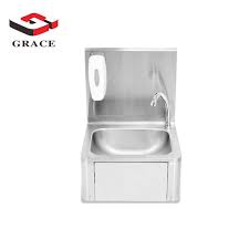 A freestanding kitchen island, containing the sink and hob, stands in front of the panelled sliding doors, while the boxy extractor fan looks like a contemporary light fitting. Grace Steel Stainless Style Hand Free Knee Operated Sink Washing Basin For Restaurant