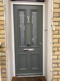 victorian front entrance door in cement grey and polished chrome hardware for more victorian design front door styles green front doors victorian front doors