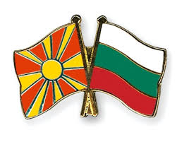 National flag consisting of a red field with a golden central disk and golden rays extending to the flag edges. Crossed Flag Pins Macedonia Bulgaria Flags