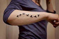 The little bird is tastefully detailed so as to ensure that the colors don't look gaudy, while retaining its essence. Bird Tattoos For Men Ideas On Arm Arm Tattoos For Guys Tattoos Small Tattoos For Guys