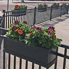 Add these deck rail planter boxes to your wooden balcony or deck rail for an instant garden anywhere! Black Railing Planters On Metal Fence At Local Restaurant Outdoor Seating Area Deck Railing Planters Railing Planters Patio Fence