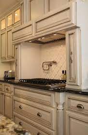These weathered hues of intricate glazing offer a subtle beauty that can only be achieved in a hand crafted tile. Arabesque Tile Traditional Kitchen M E Beck Design