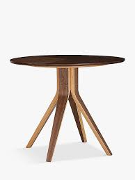 John lewis colorful cola red dining furniture with a round silver dining table that has flowers and saved colorful plates and cups on top.this dining has colorful furniture,the floor is wooden,the wall is in white and there is nice picture stuck on the wall in front of the room. Anyday John Lewis Partners Radar 4 Seater Round Dining Table