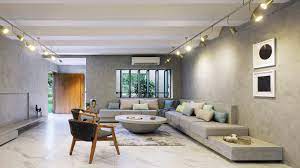In this modern living room, gold accents enhance the honey tones of the wooden floor and the richness of the leather chair. 8 Essential Tips For Designing A Modern Living Room Architectural Digest India