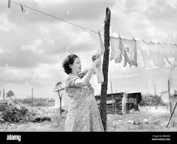 Mrs. Agnes Usher hanging Clothes at her new prefabricated house at  Hazlehurst Farms Inc., Hazlehurst, Georgia, USA, Jack Delano, U.S. Office  of War Information, April 1941 Stock Photo