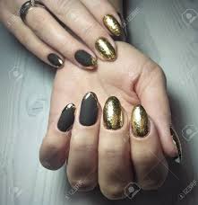 Depends on what condition your own nails are, quality of. Long Round Nails With Black Matte Gel Polish And Gold Design Stock Photo Picture And Royalty Free Image Image 138553392