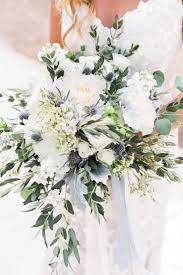 A Rustic Romantic Bouquet Of White Dahlias Wax Flower White Stock Blue Thistle Eucalyptus Blue Wedding Bouquet White Roses Wedding Thistle Wedding Flowers