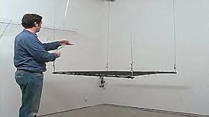 • employ the pulley system for a little elbow grease. Racor Cable Lifted Pulley System Garage Storage Rack Gif Overhead Garage Storage Overhead Storage Garage Storage Racks