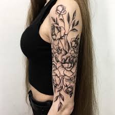 This large tattoo depicts leafy vines combined with flowers and a cat! 13 Tattoo Artists Share Some Of The Beautiful Flower Tattoos They Have Done