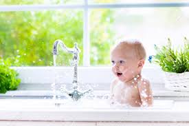 Huge collection, amazing choice, 100+ million high quality, affordable rf and rm images. Baby Taking Bath In Kitchen Sink Child Playing With Foam And Soap Bubbles In Sunny Bathroom
