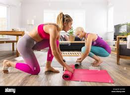 Image of happy diverse lesbian couple preparing mats for yoga at home Stock  Photo - Alamy
