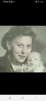 Kitzingen, Germany 1957. Teaching our German landlord's kids Karli und  Peter the finer points of pumpkin carving for Halloween. Mom is holding my  little sister Els. Behind her is her small cold