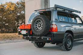 You begin building your rear bumper and tire carrier by first selecting the main rear bumper portion and then you have to choose one of three choices for both the left and right sides of the carrier. Dobinsons Rear Bumper With Swing Outs For Toyota Landcruiser 100 Serie Dobinsons Direct
