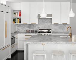 See more ideas about gold kitchen, kitchen inspirations, kitchen hardware. Sleek White Island Stools At A White And Gray Kitchen Featuring A Brushed Gold Faucet And White Kitchen Cabinets Blue Kitchen Designs White Marble Countertops