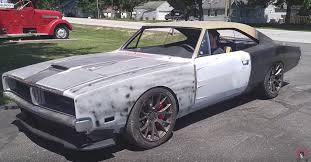 The dodge challenger is the name of three different generations of automobiles (two of those being pony cars) produced by american automobile manufacturer dodge. Someone Restomodded A 1969 Dodge Charger To Hellcat Status