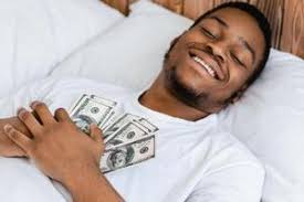 Unrecognizable Rich African American Man Sleeping Holding Money Dollars  Cash Dreaming About Financial Wealth Lying In Bed At Home. Finances Income  And Savings Safety Concept. Cropped, Top View 60709386 Stock Photo at