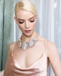 Behind the scenes with Anya Taylor-Joy as she prepares to attend the 82nd  annual Golden Globe Awards. Anya wears the Blue Book 2024: Tiffany Céleste  Star Burst Crystal Opal necklace in platinum