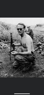 Erik Bonde, a Swedish Major fighting in the Congo Crisis, smokes a  cigarette after being shot twice in the chest following an ambush. Jan 1961  [800x1150] : rHistoryPorn