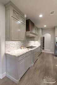 They are an important aspect of any kitchen remodeling process because they impact the overall appearance of your kitchen. Custom Home Builder Tulsa Ok Rustic Glam Kitchen With Glass Tile Backsplash Granite Counters Metallic Strie Glam Kitchen Taupe Flooring Kitchen Cabinets