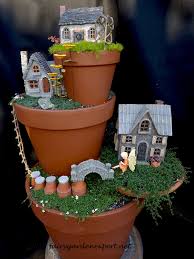 The moment that spring weather hits, get the kids outside and make this diy boho fairy garden in your backyard. Stack Pots To Create A Verticle Fairy Garden Fairy Garden Diy Fairy Garden Decor Garden Ideas Homemade