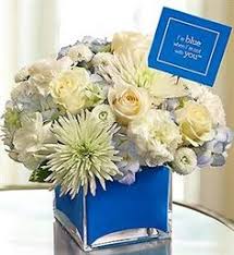 This bouquet of blue hydrangeas mixed with white roses makes for a stunning mix of modern and traditional florals, perfect for a new baby boy. 14 Baby Boy Arrangements Ideas Flower Arrangements New Baby Flowers Floral Arrangements