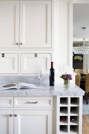 Fabulous Kitchen Features Creamy White Shaker Cabinets Fitted With An Under The Counter Vertical Win Kitchen Island Storage Built In Wine Rack Kitchen Interior