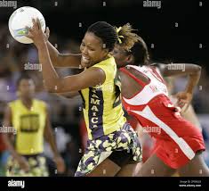 Jamaica's Tamara Bryan, left, catches the ball in front of Sonia Mkoloma of  England during the Commonwealth Games netball bronze medal play off in  Melbourne, Australia Sunday March 26, 2006. (AP Photo/Tony