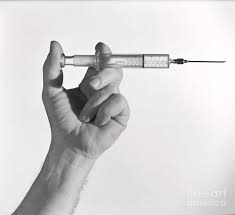 A syringe is a simple reciprocating pump consisting of a plunger (though in modern syringes, it is actually a piston) that fits tightly within a cylindrical tube called a barrel. Hand Holding Syringe By Bettmann