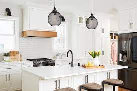 Most unfinished cabinets come from the factory sanded smooth enough to stain, but it is a good idea to lightly sand all surfaces with apply the stain to one surface at a time, wait five minutes or so, then wipe it off with a clean white cotton cloth. Range Hood Wainscoting With Stained Wood Trim Transitional Kitchen