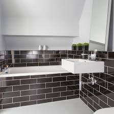 Blackened bronze fixtures helps this shower to feel integrated into the space. Black And White Bathroom Designs Ideal Home