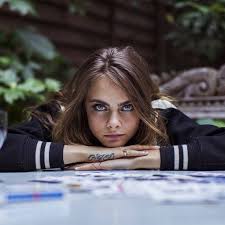 It features a snake that starts at her palm and slithers down her middle finger, and the word feral. Cara Delevingne S Tattoos Tattoofilter