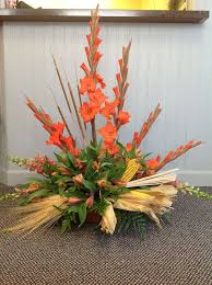 Orange Glads Orange Snapdragons Along With Wheat And Corn For A Farmer Flower Centerpieces Funeral Flowers Altar Flowers
