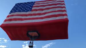 At 180 feet in height, the top of the metal flagpole towers 90 feet above an overpass junction of state route 16. World S Largest Free Flying Flag Balloon Honors America And Female Veterans Abc7 New York